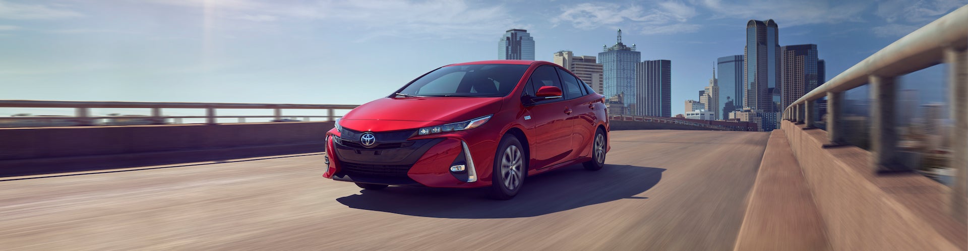 Bennett Toyota of Lebanon is a Car Dealership near Harrisburg, PA | 2020 Toyota Prius Prime driving away from city