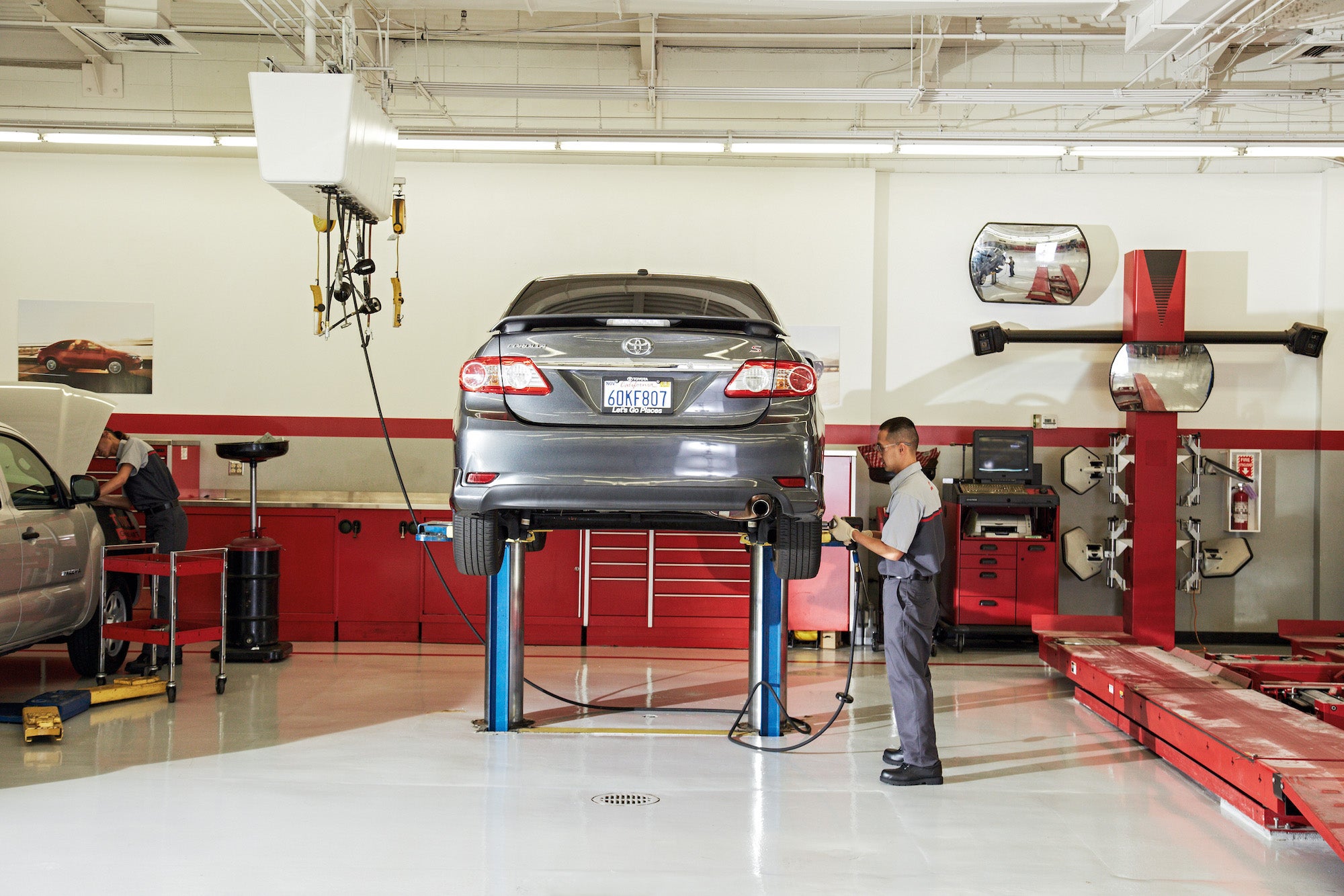 Bennett Toyota of Lebanon is a Car Dealership near Sand Hill, PA | Toyota service attendant working on Toyota vehicle on lift