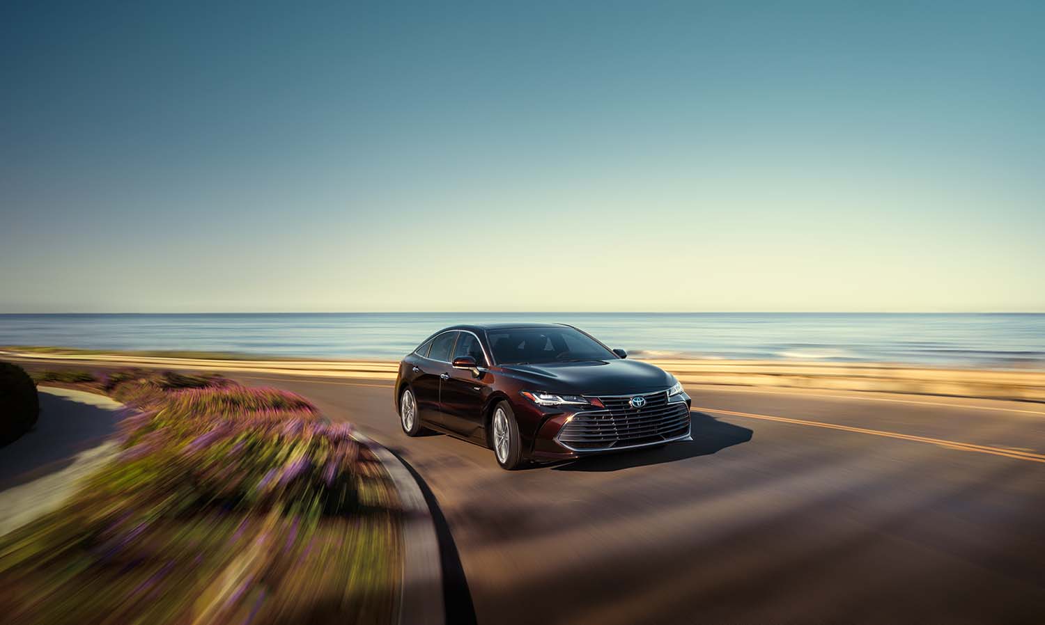 Toyota Hybrid for Everyone at Bennett Toyota of Lebanon | 2022 Toyota Avalon driving by the beach
