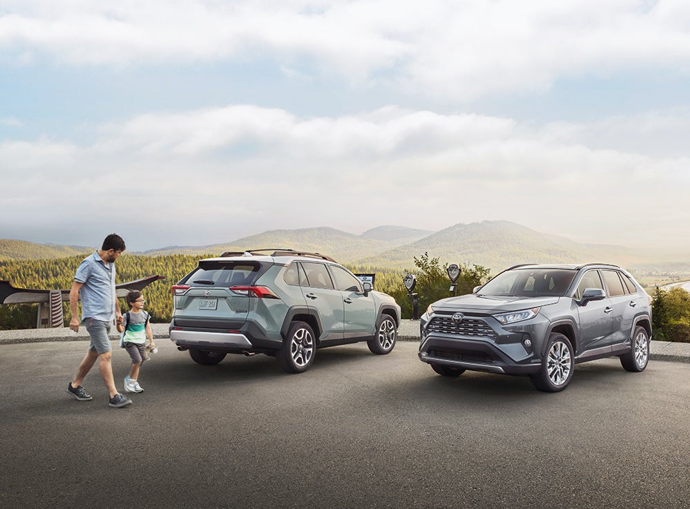 Compare the 2021 Toyota RAV4 vs. the 2021 Honda CR-V at Bennett Toyota of Lebanon | Two 2021 Toyota RAV4s parked at the top of a hill