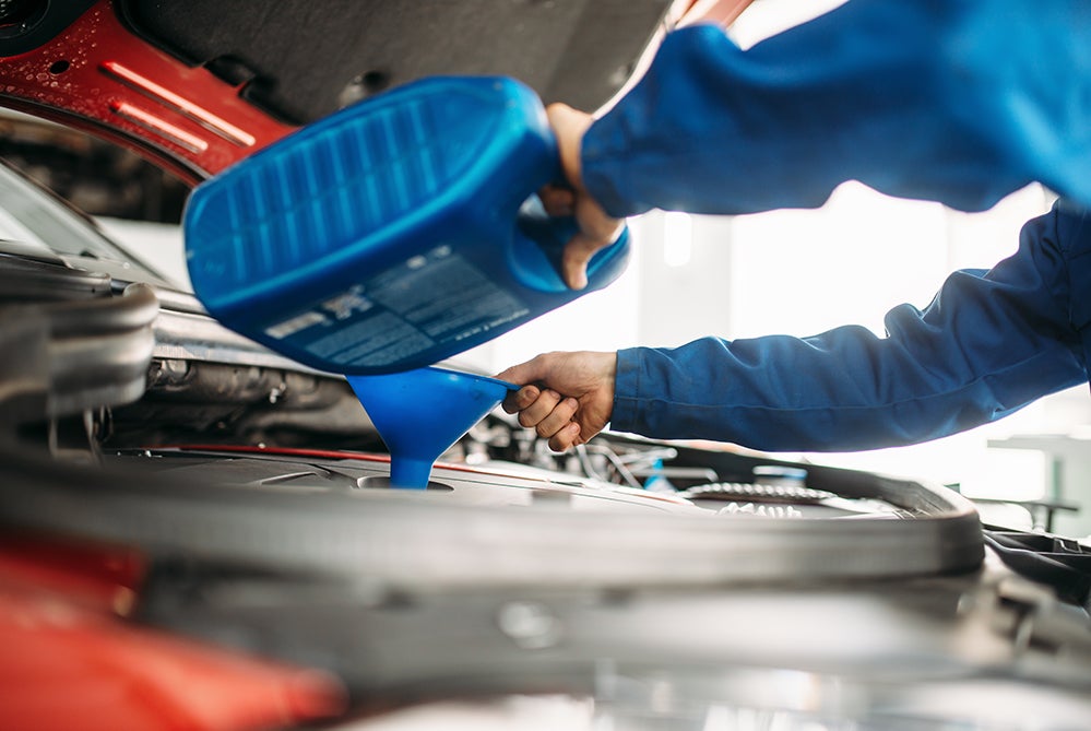 Benefits of Changing Your Toyota’s Oil at Bennett Toyota in Allentown | Technician Changing Engine's Oil